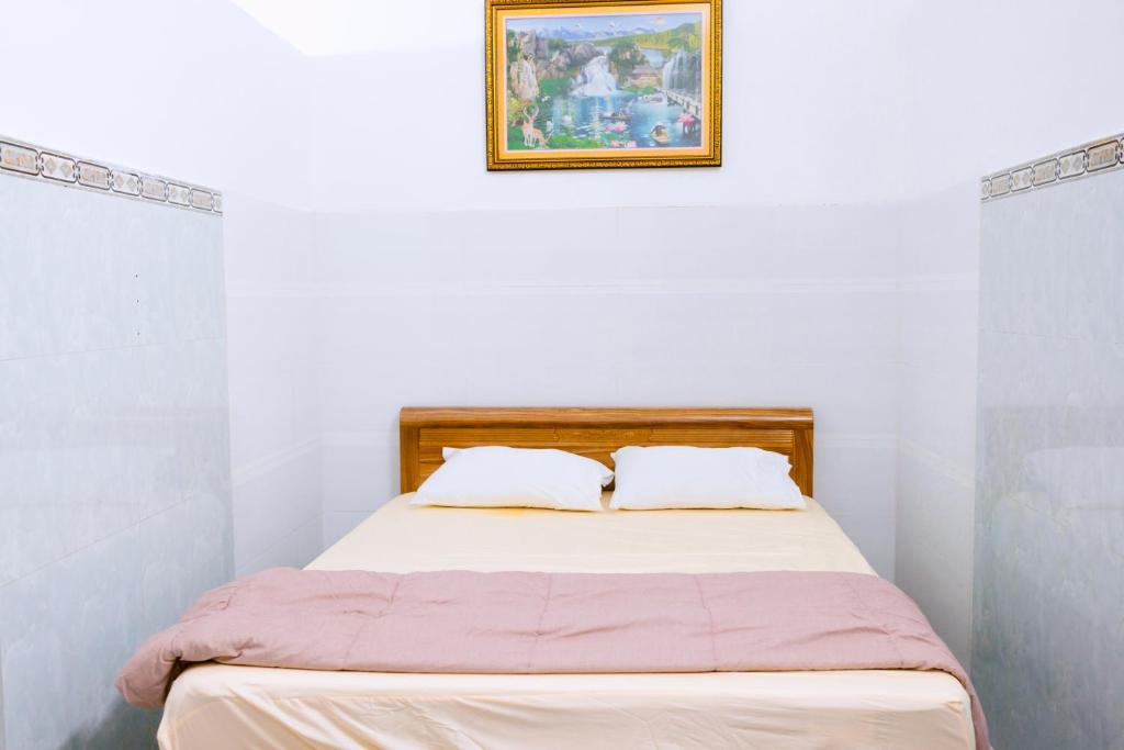 a bed with two white pillows in a white room at Hồng Diễm Lagi homestay in La Gi