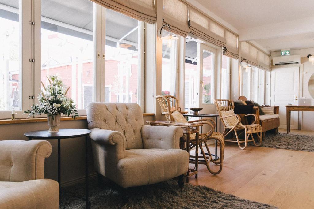 a lobby with chairs and tables and windows at Pariisin Ville in Porvoo