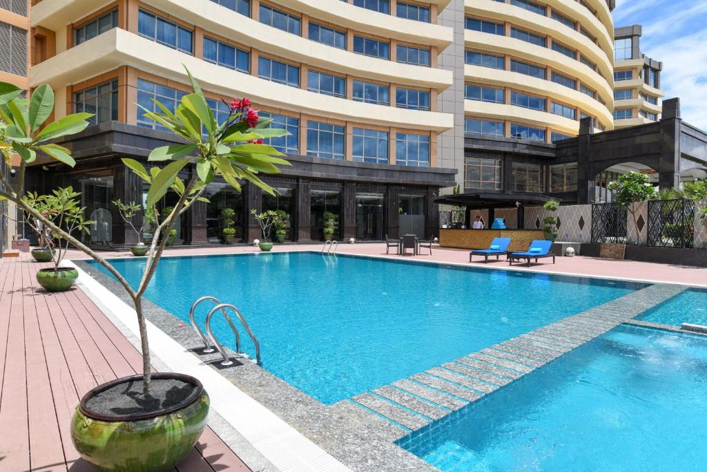 a swimming pool in front of a building at Royal Tian Li Hotel in Yangon