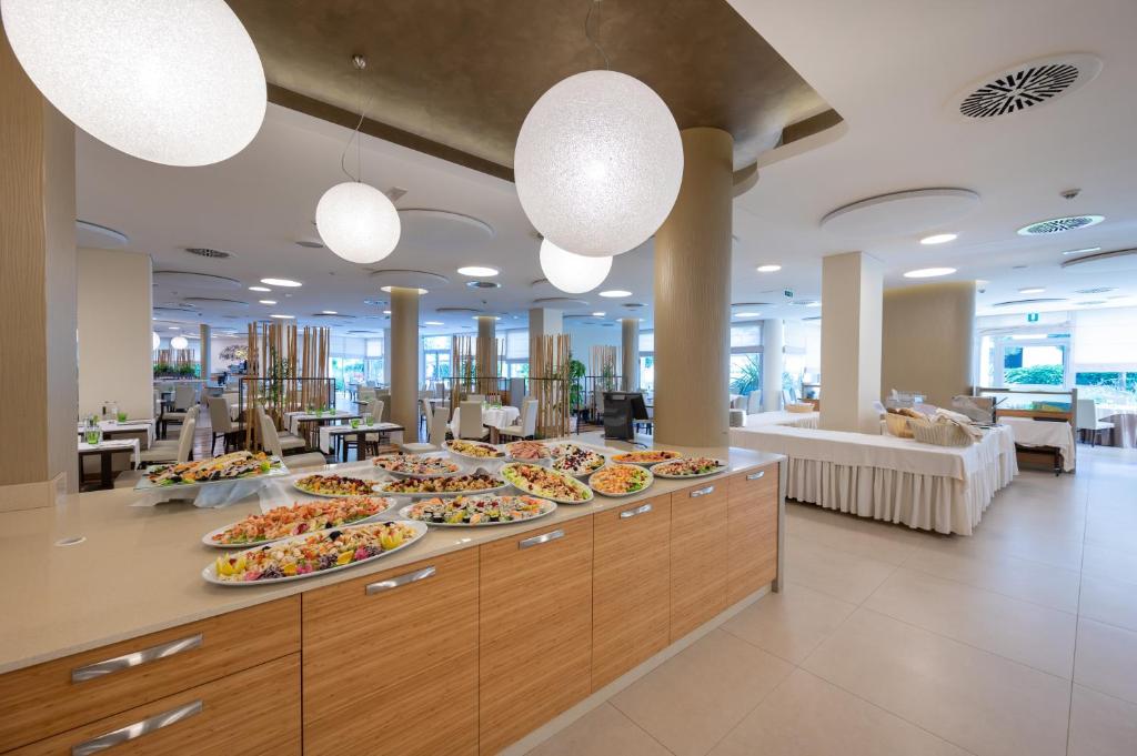 a buffet line with many plates of food at Laguna Park Hotel 4Superior in Bibione