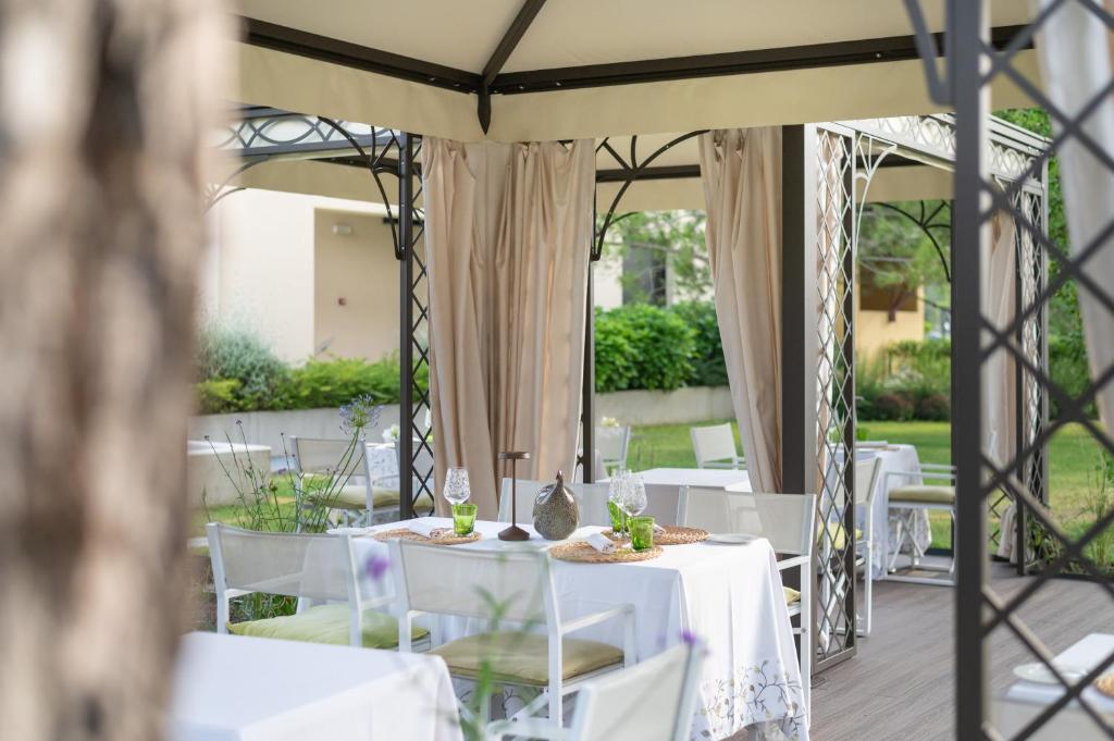 a table set up for a wedding under a tent at Laguna Park Hotel 4Superior in Bibione
