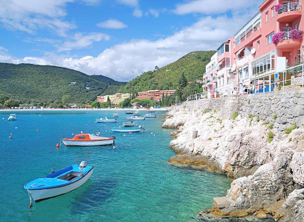 a group of boats in the water next to buildings at Apartment Betty in Labin