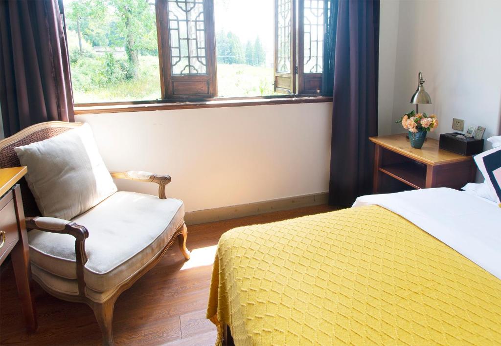 Postel nebo postele na pokoji v ubytování Alina Garden Boutique Resort Huangshan Hongcun