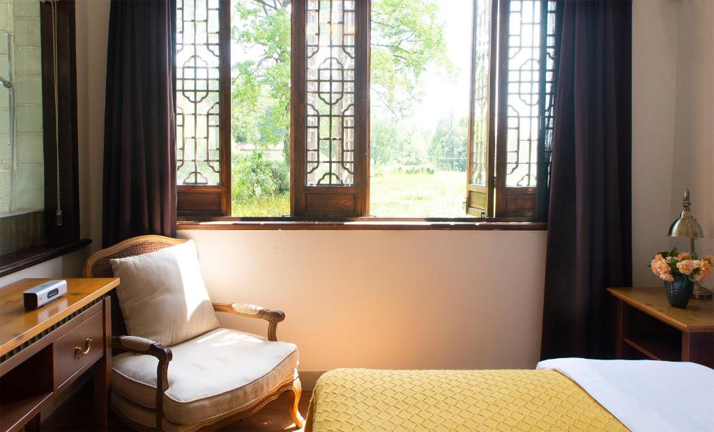 Postel nebo postele na pokoji v ubytování Alina Garden Boutique Resort Huangshan Hongcun