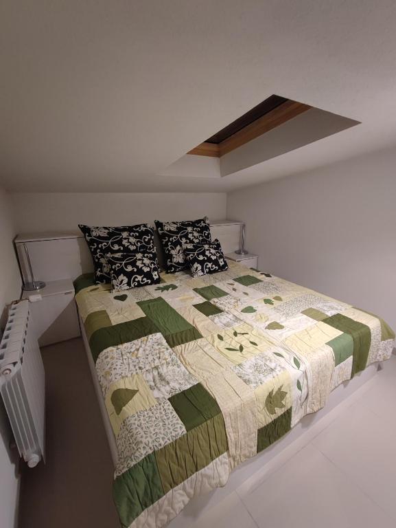 a bedroom with a bed with a quilt on it at APARTMANI VIJEĆNICA in Sarajevo