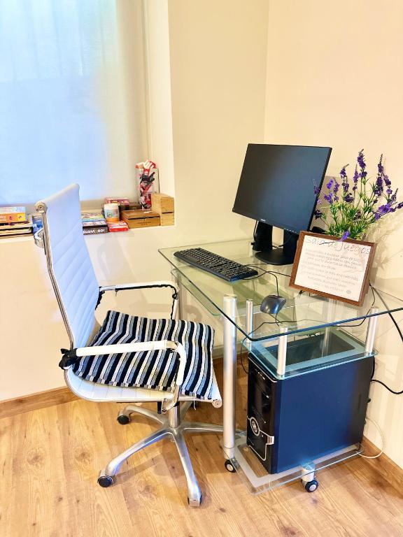 an office with a desk with a computer and a chair at Hotel Las Olas in Noja