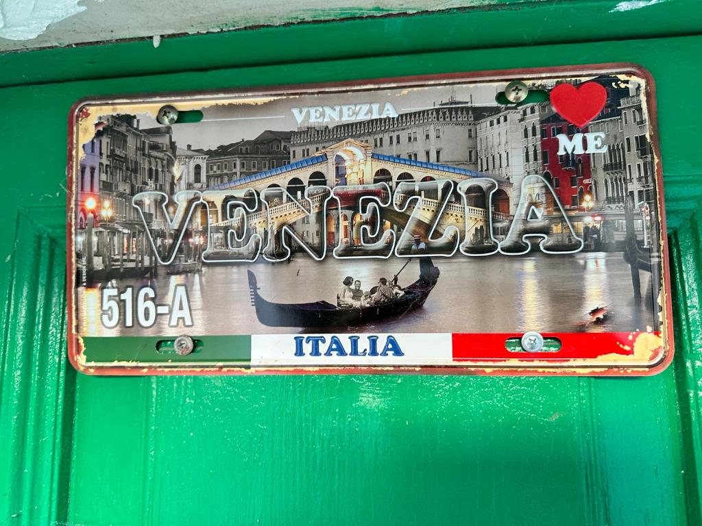 a sign on a wall with a picture of a boat at Venezia in Abruzzo in Archi