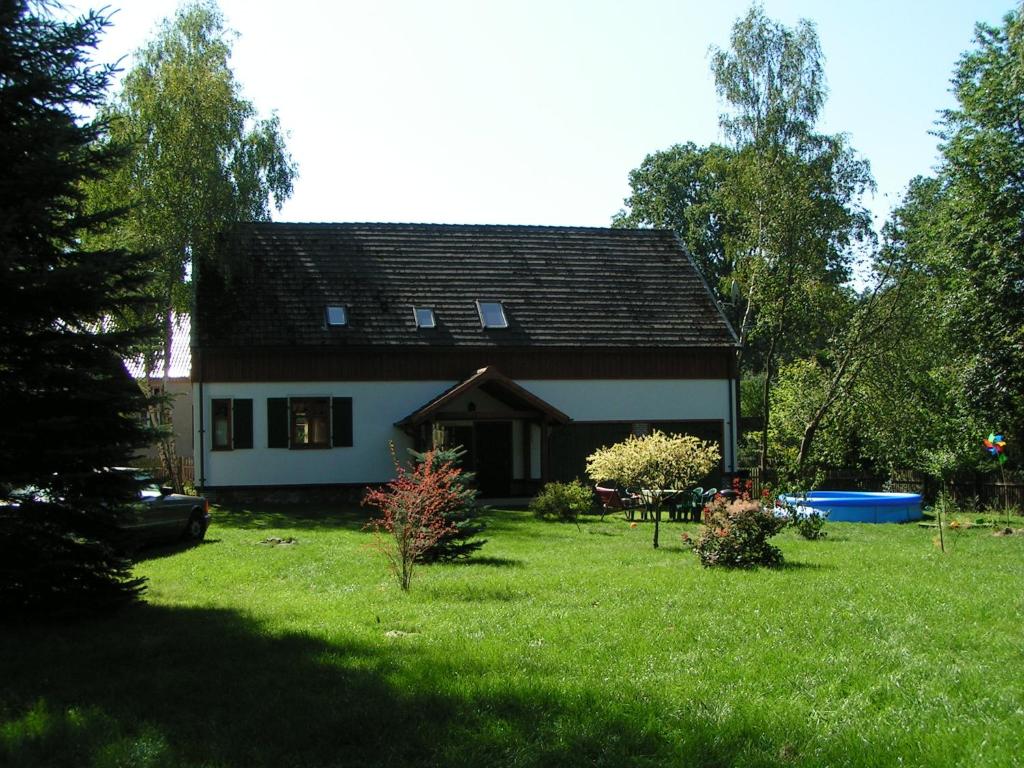 a house with a large yard in front of it at Aulichówka - Dom Wakacyjny i Squash in Gryżyna