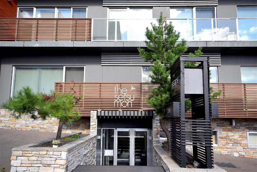 a building with a sign on the front of it at The Setsumon in Kutchan