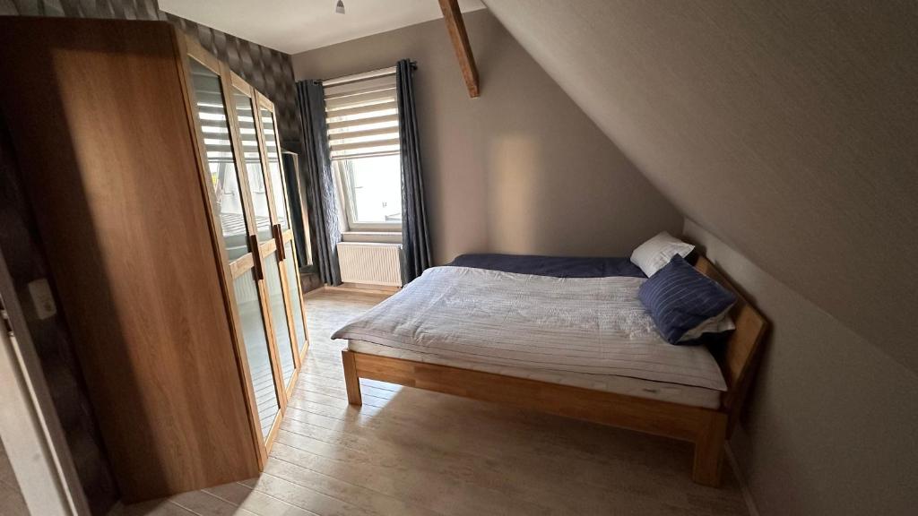 Dormitorio pequeño con cama en el ático en Ferienhaus im Grünen 