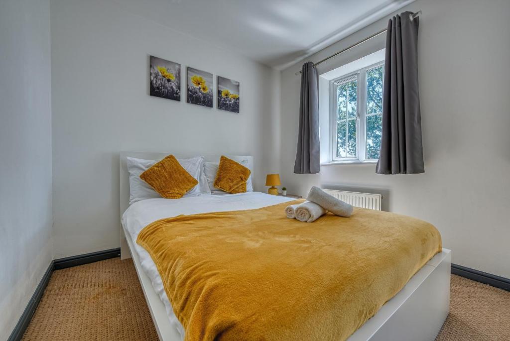 a bedroom with a bed with a teddy bear on it at NEC Exhibitor Home, Stay near Birmingham Airport in Birmingham