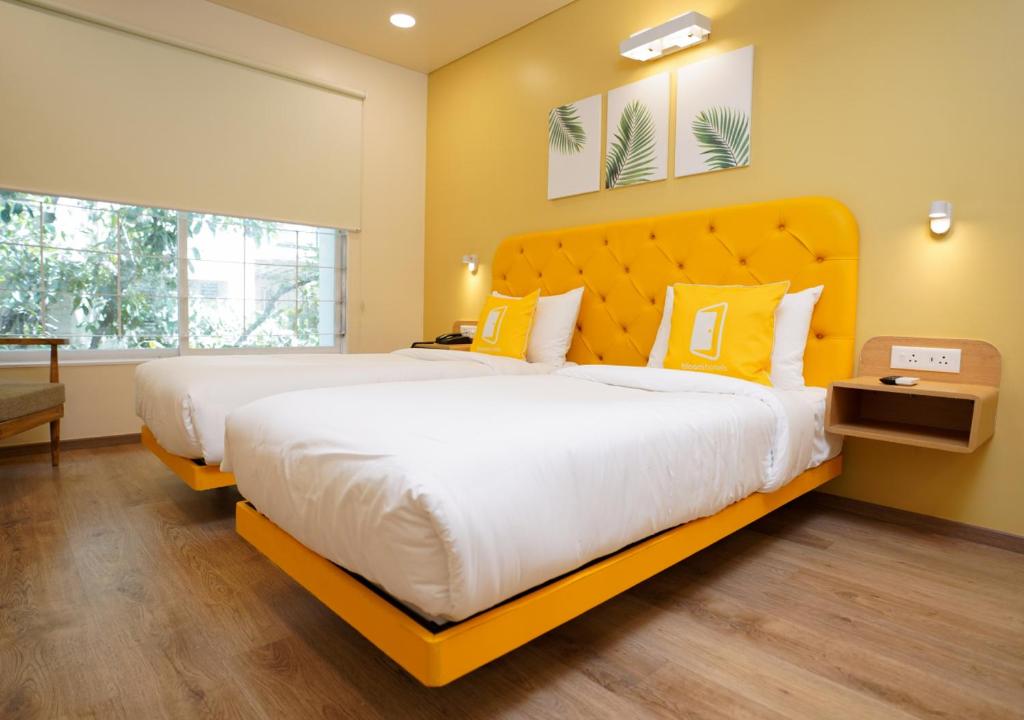 Postel nebo postele na pokoji v ubytování Bloom Hotel Koregaon Park