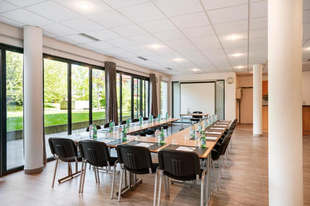 a large conference room with a long table and chairs at Residhome Paris-Evry in Courcouronnes