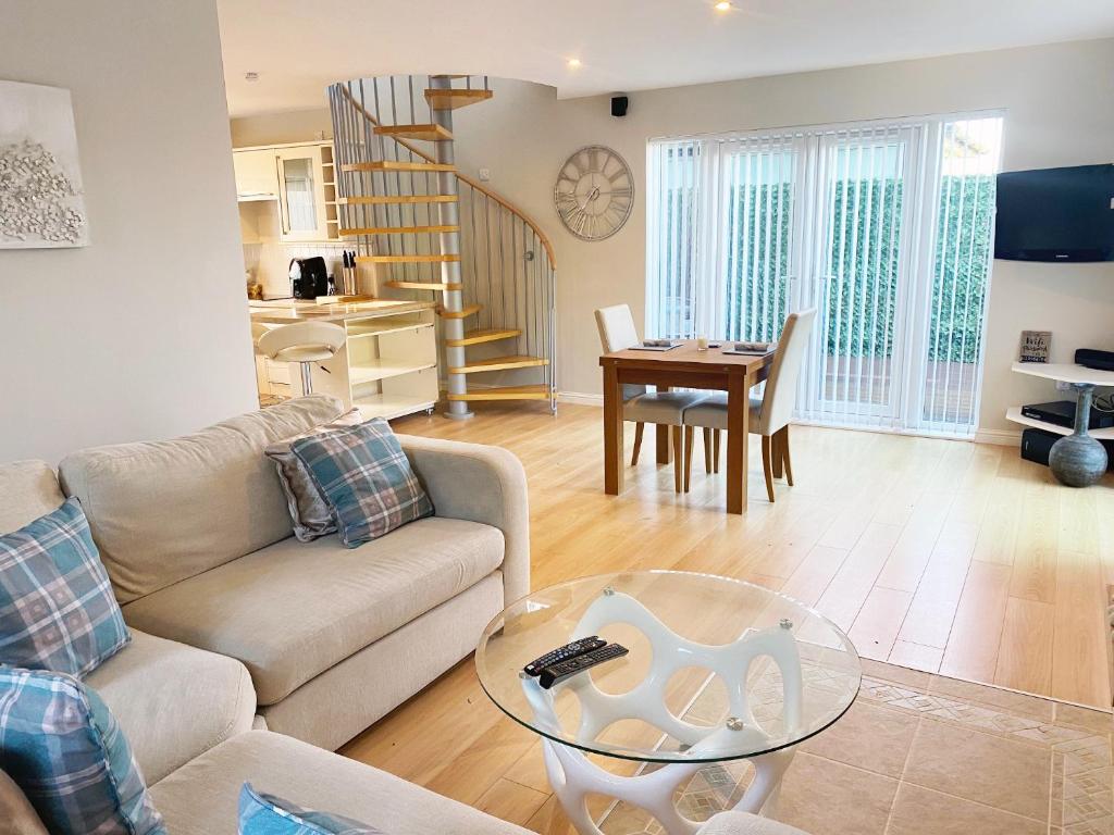 a living room with a couch and a glass table at Castlehill in Dundee