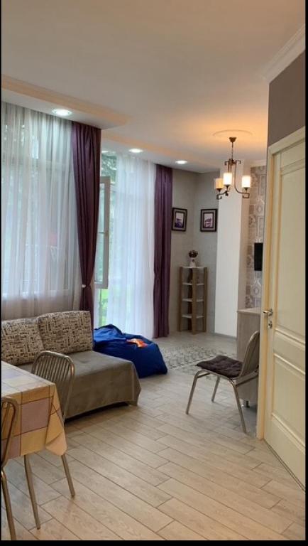 a living room with a couch and a table at 1st line apartment in Kobuleti in K'obulet'i