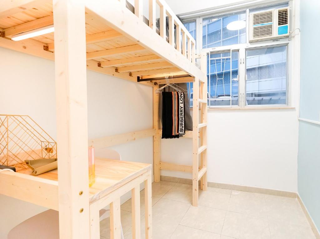 a loft bed in a room with a staircase at Shared dormitory Wan Chai Road 187 in Hong Kong