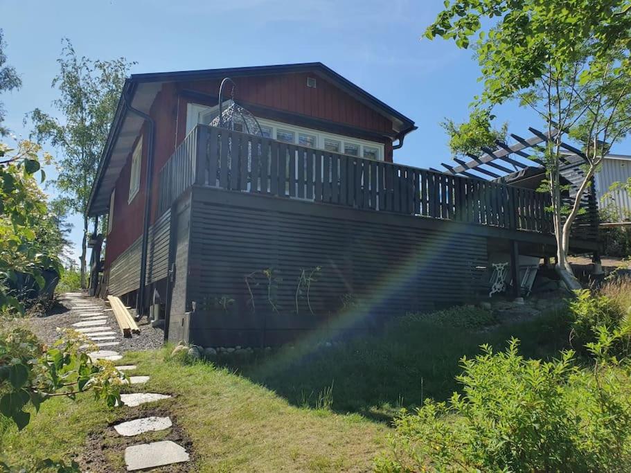 a house with a balcony on the side of it at Stugan in Stockholm