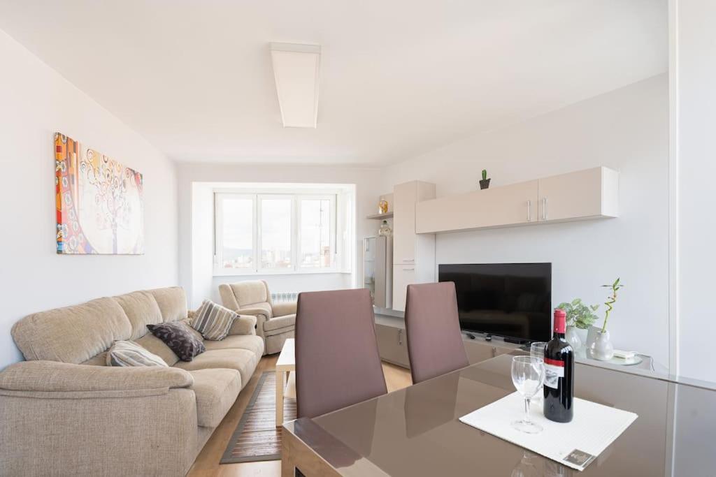 a living room with a table and a couch at MyHouseSpain - Moderno piso frente al mar in Gijón
