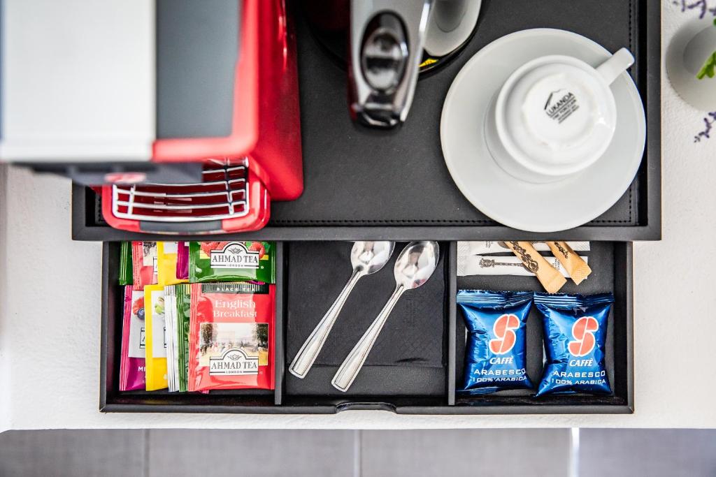 a drawer with utensils and a plate on a table at Skopelos Holidays Hotel & Spa in Skopelos Town