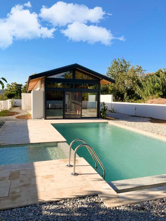 a swimming pool in front of a house at Koy Villa in Muğla