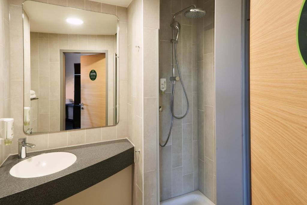 a bathroom with a sink and a shower at B&amp;B Hotel Heidelberg in Heidelberg