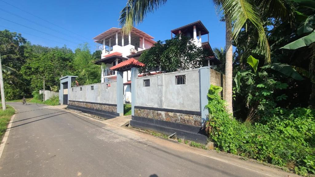a house on the side of a road at Villa Crimson Bay in Unawatuna