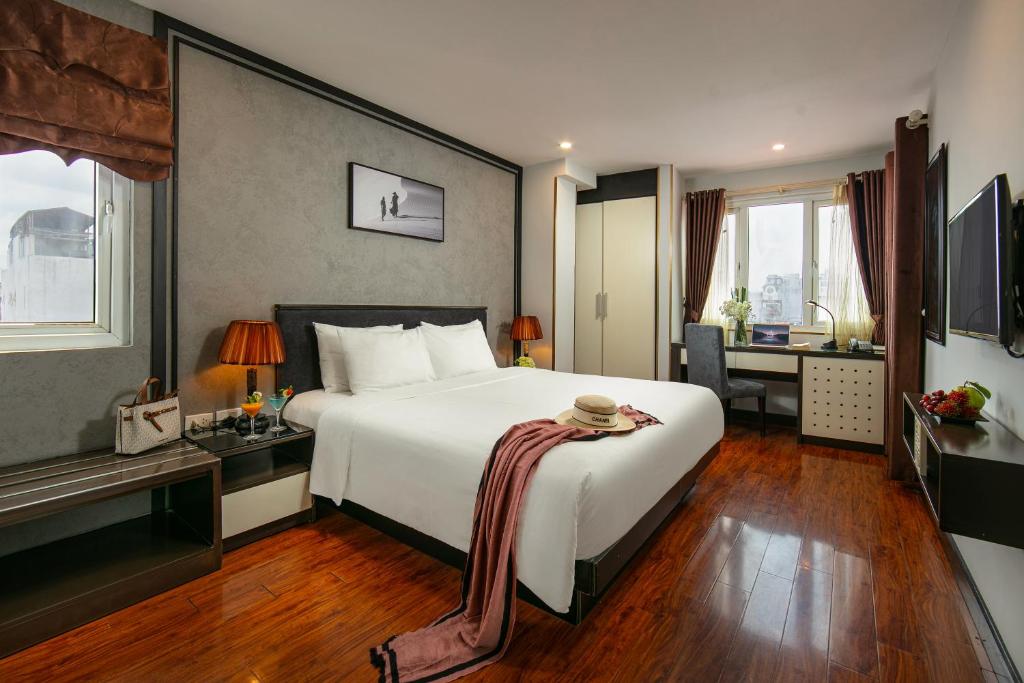 Postel nebo postele na pokoji v ubytování Hanoi La Palm Premier Hotel & Spa