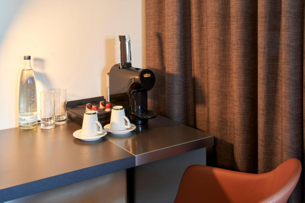 a hotel room table with a coffee maker on it at B&amp;B Hotel Heidelberg in Heidelberg