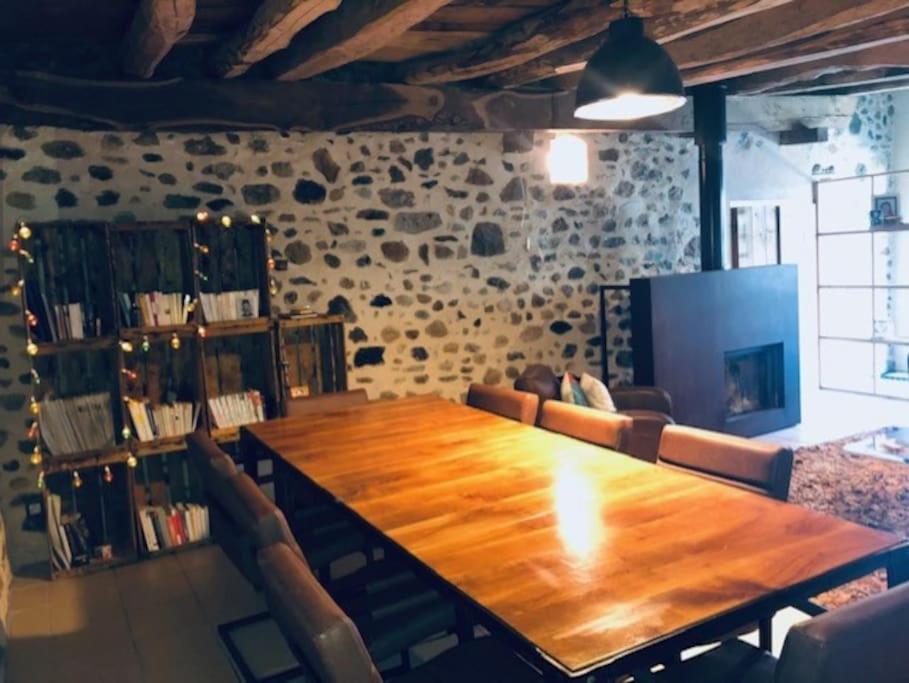 a large wooden table in a room with chairs at Belle maison familiale à la campagne in Saint-Girod