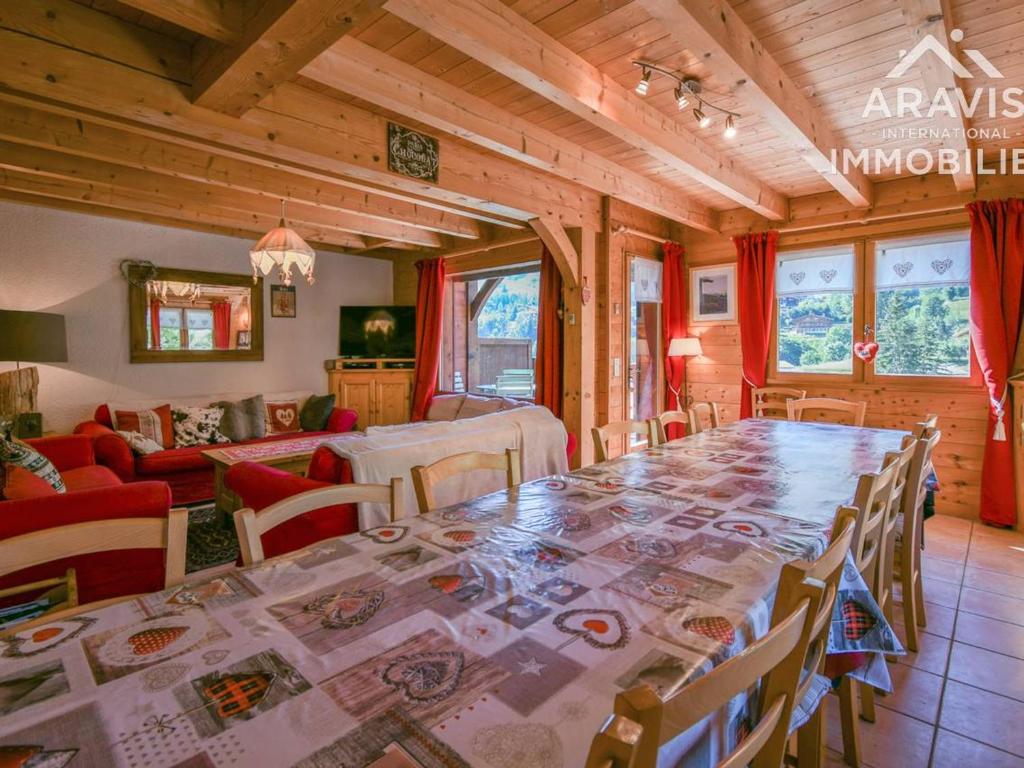 a dining room with a large table and chairs at Chalet Le Grand-Bornand, 8 pièces, 16 personnes - FR-1-391-33 in Le Grand-Bornand