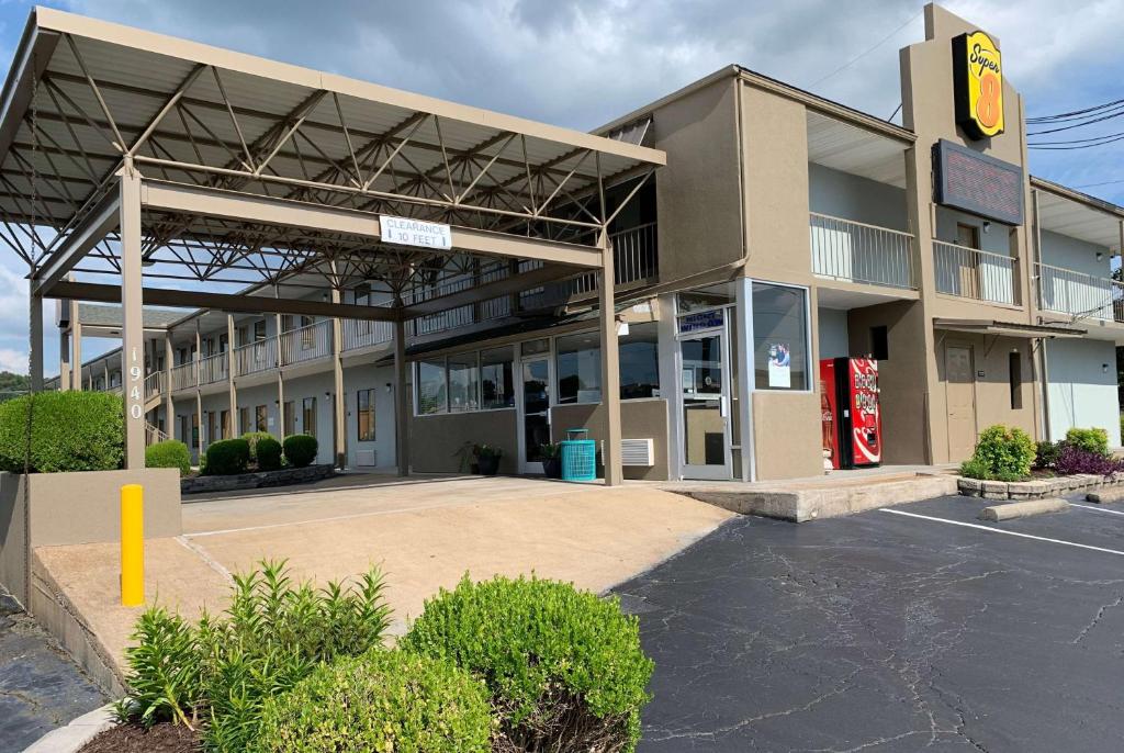 a building with a gas station in front of it at Super 8 by Wyndham Jackson in Jackson