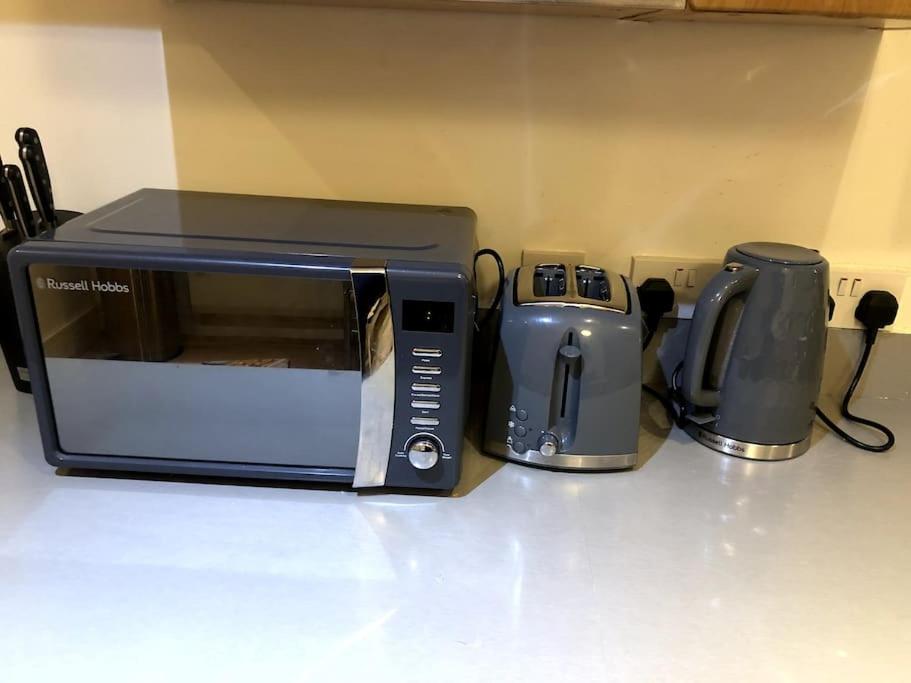 a microwave and a coffee maker on a counter at Beautiful Central Open plan living! in Manchester