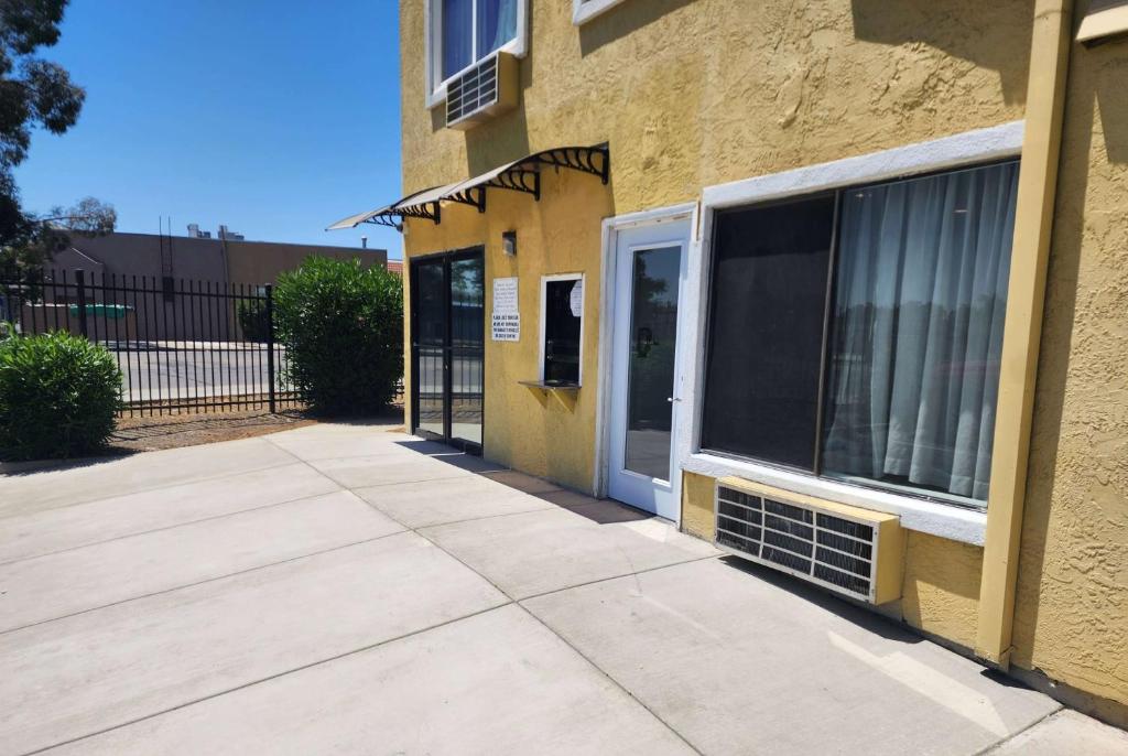 a yellow building with a door and a window at Travelodge by Wyndham Stockton in Stockton