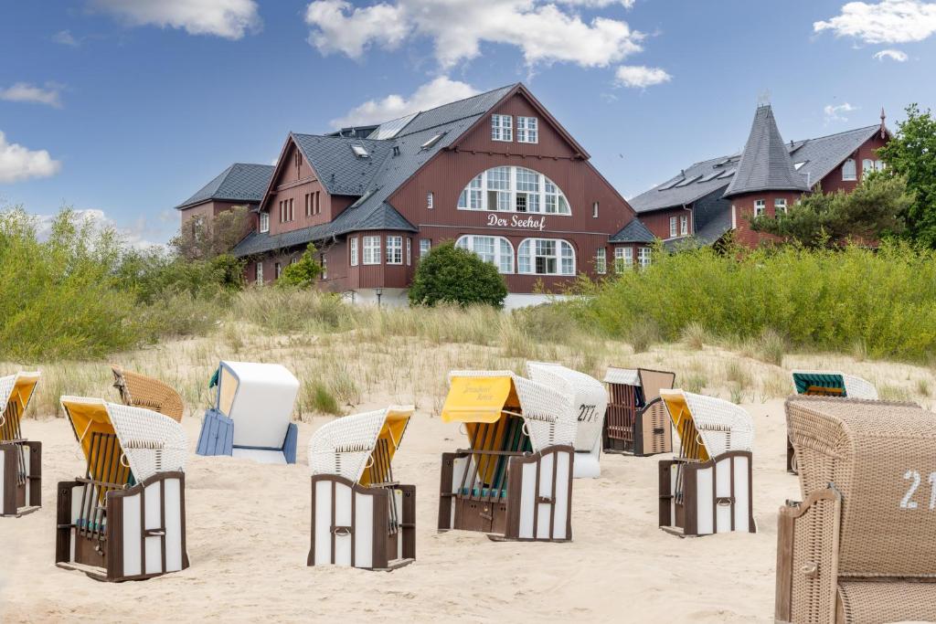 a bunch of chairs in the sand in front of a building at Seehof Seehof 2 0 in Bansin