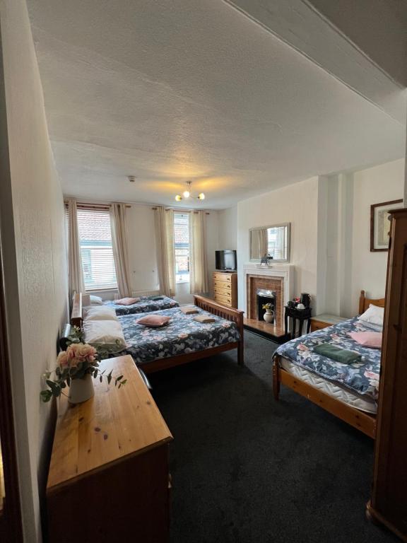 a hotel room with two beds and a table at The Watergate Inn in York