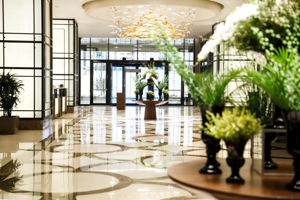 a lobby with vases of flowers in a building at Sheraton Grand Istanbul Atasehir in Istanbul
