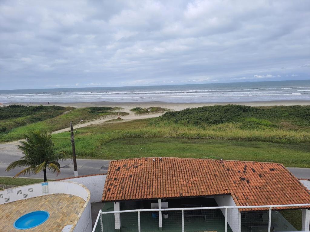 a building with a view of the beach and the ocean at Apto de frente ao mar Itanhaém in Itanhaém