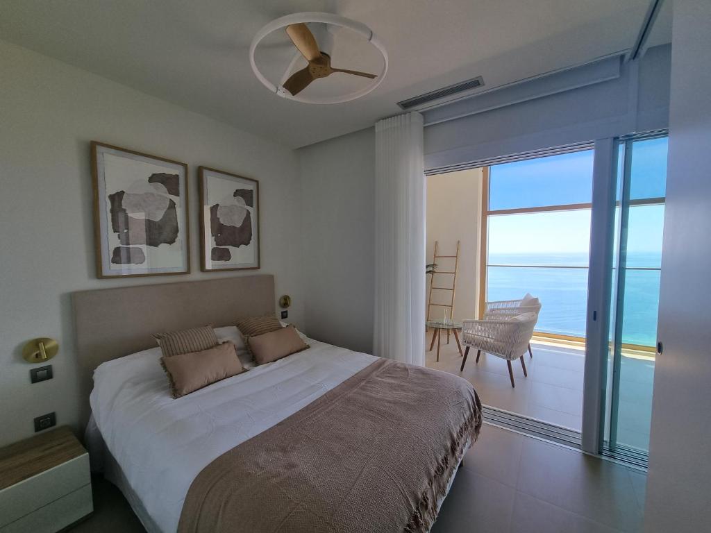 a bedroom with a large bed with a view of the ocean at Floor 32! INTEMPO Luxury in Benidorm