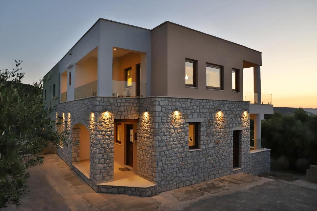 a house with lights on the front of it at NiMar Villa in Sitia