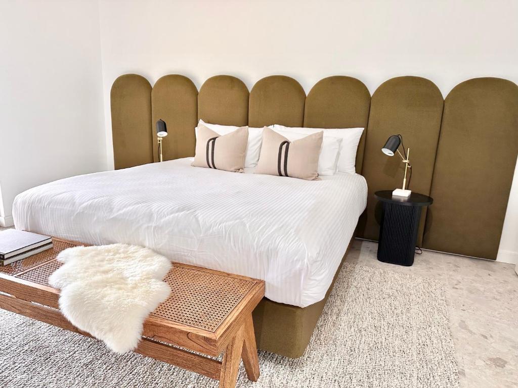 a bedroom with a large bed with a large headboard at Chambré Estate in Margaret River Town