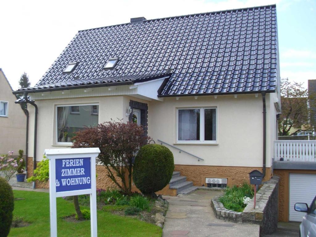 a house with a for sale sign in front of it at Ferienwohnung Am Stadtrand in Dwasieden