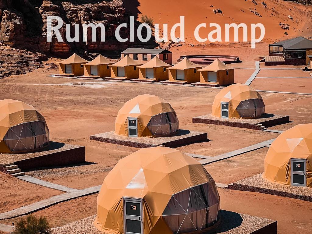 a group of tents in a desert with the words run down camp at Rum cloud camp in Wadi Rum
