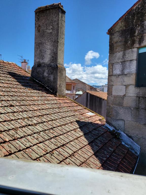 a tile roof with a tower on top of a building at CASA MARUXA pensión in Pontevedra