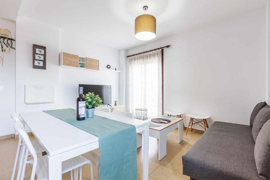 a living room with a table and a couch at A&N Beach Walk Couples Retreat Torre del Mar in Torre del Mar