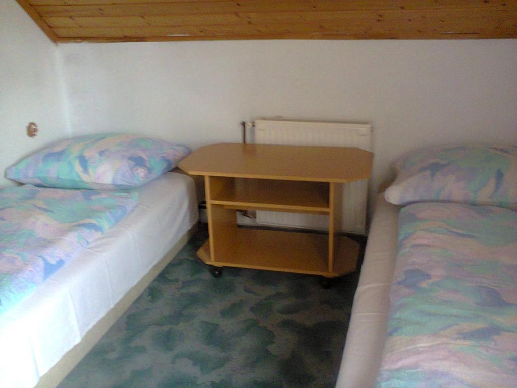 A bed or beds in a room at F 106 Vendégház