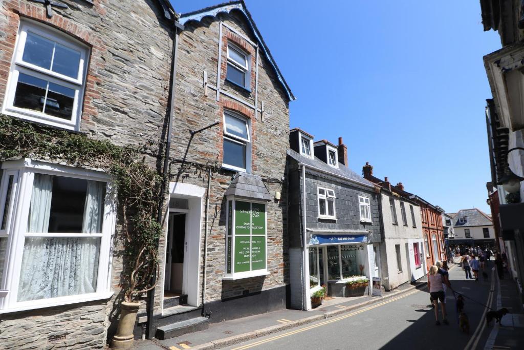 a street with buildings and people walking down the street at Town centre apartment with parking in Padstow