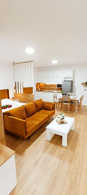 a living room with a couch and a table at Selvia Apartament in Tirana