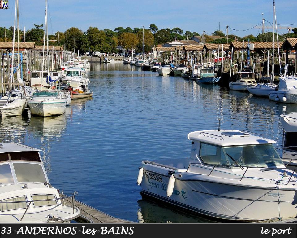 a bunch of boats are docked in a marina at Andernos-Maison de centre-ville avec jardin in Andernos-les-Bains