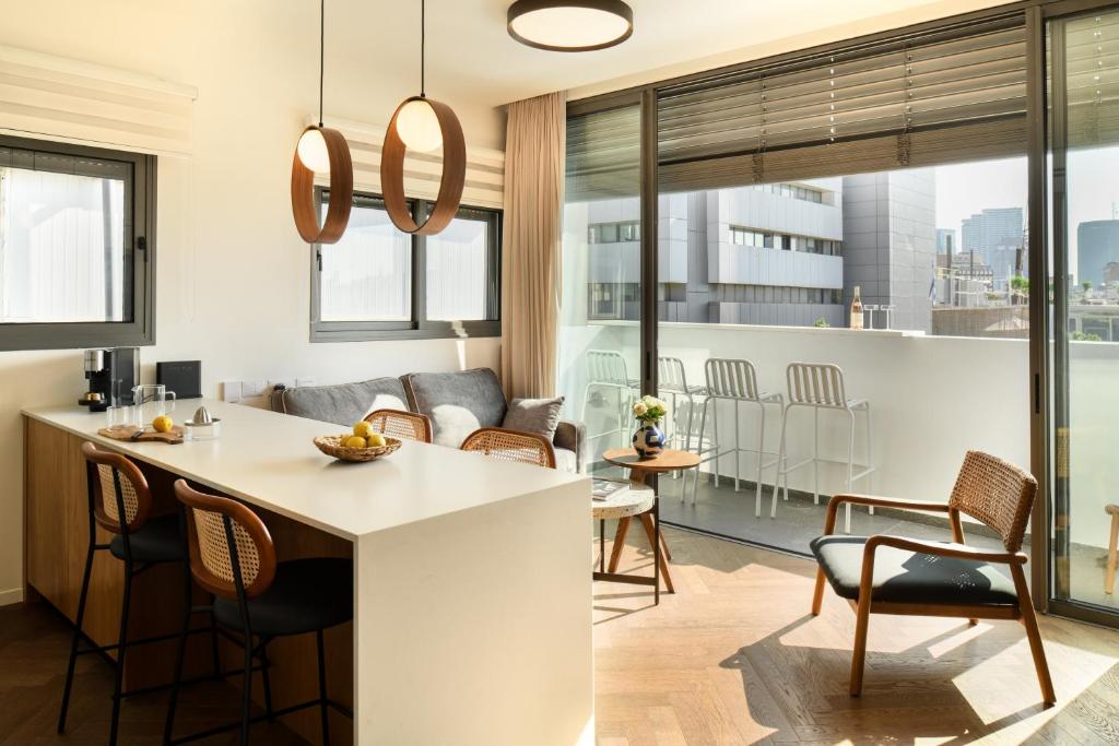 a kitchen and living room with a table and chairs at Balcony Bar Skyline View by Sea N' Rent in Tel Aviv