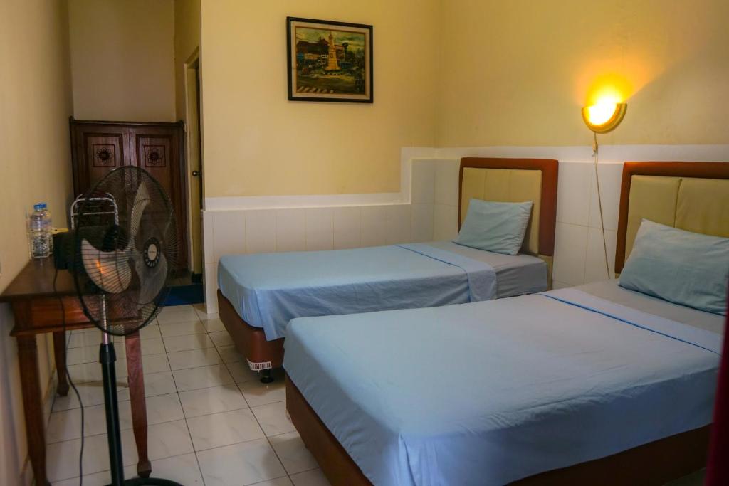 Ένα ή περισσότερα κρεβάτια σε δωμάτιο στο Hotel Tulips